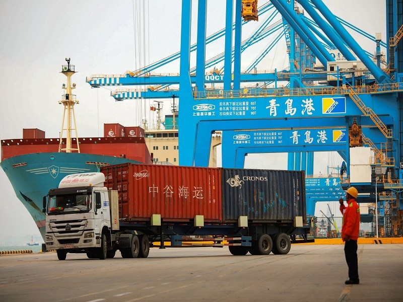 A staff member watches over a truck as he talks on his interphone at a port in Qingdao, east China's Shandong province on November 8, 2018. - China's exports to the US and the rest of the world grew more than expected in October, official data showed on November 8, as its traders apparently rushed shipments across the Pacific ahead of higher tariffs. (Photo by STR / AFP) / China OUT        (Photo credit should read STR/AFP via Getty Images)