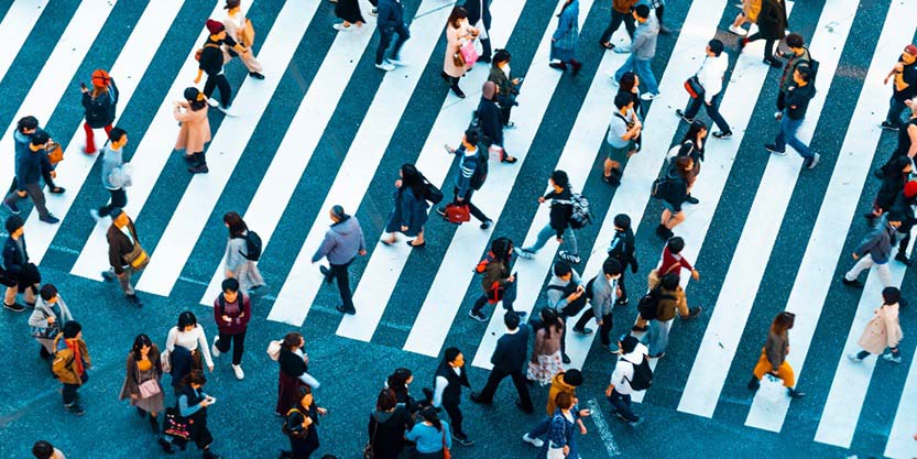 Aerial view of multiple people crossing the Zebra crossing 