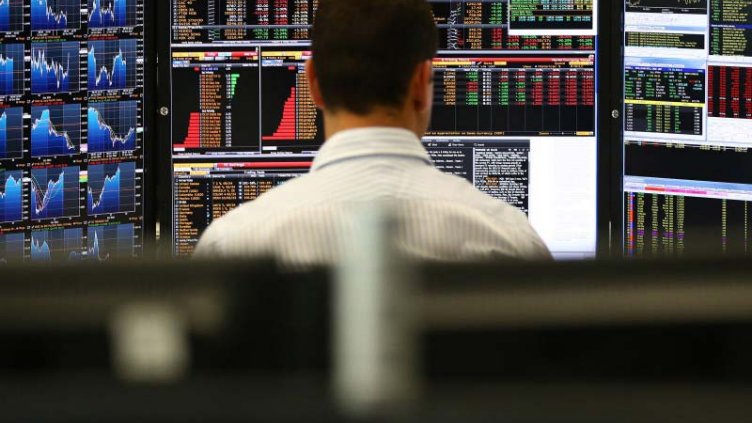 behind view of a man studying APAC REIT capital records on computer.