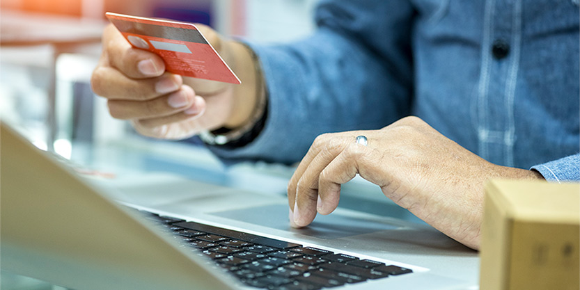 Man holding a credit card, getting ready for online shopping