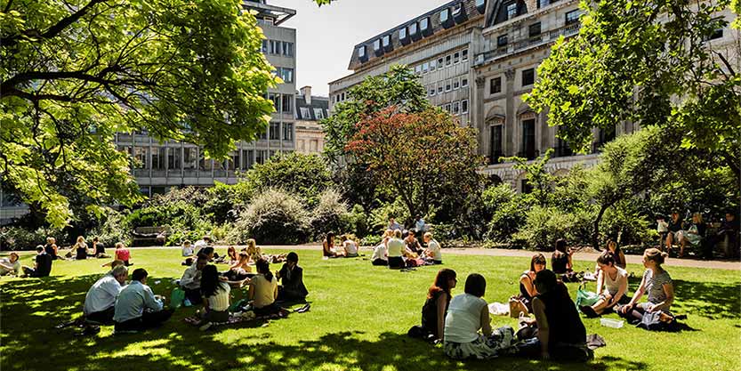 People relaxing in urban green space on a sunny day