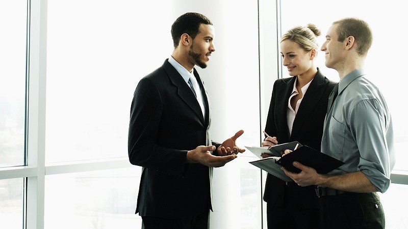 Manager having conversation with their colleagues after the meeting