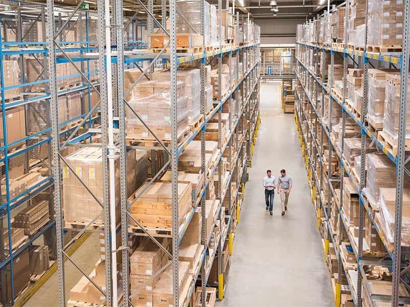 Two men walking in the warehouse