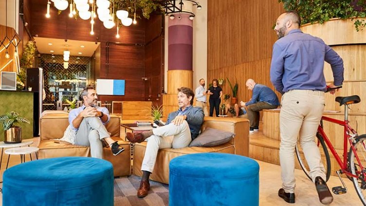 Welcoming workplace lobby with people sitting and talking
