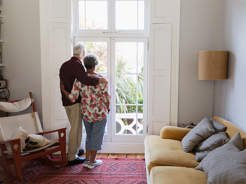 Two people looking outside the door