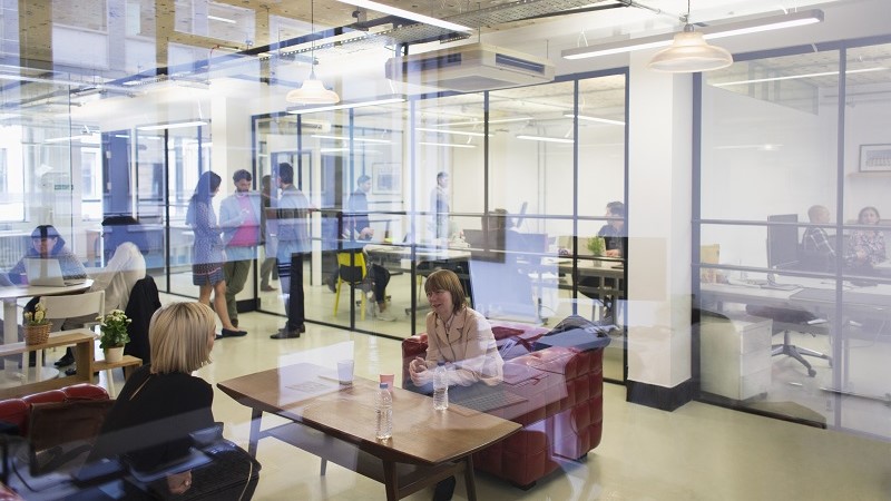 View of employees talking and discussing inside JLL office premises