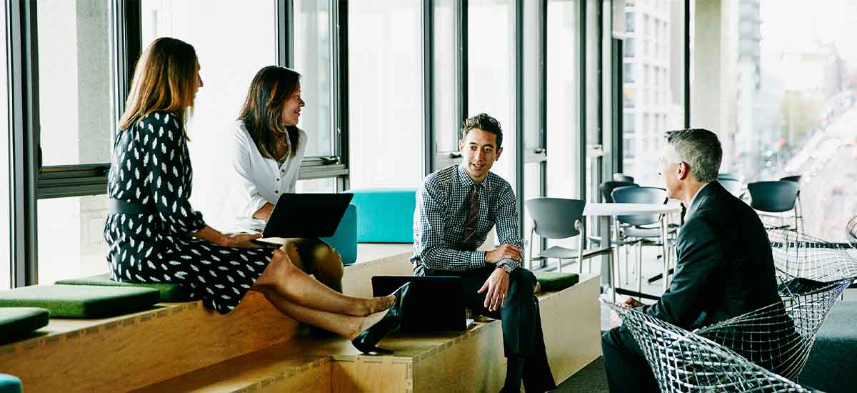 collegues having informal meeting in office