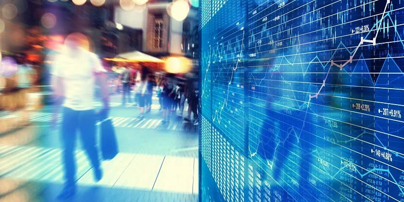 Fast paced shot of a man passing by the borrowing and investment path graph on screen